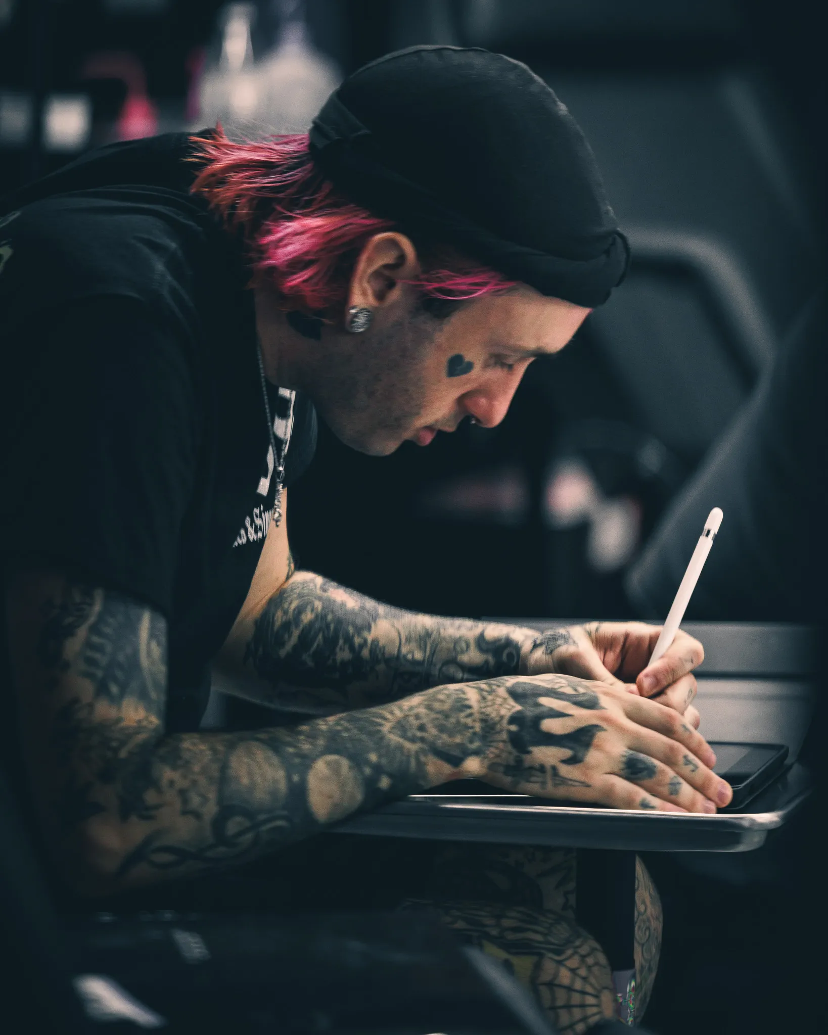 Tattoo artist working with a client in the studio