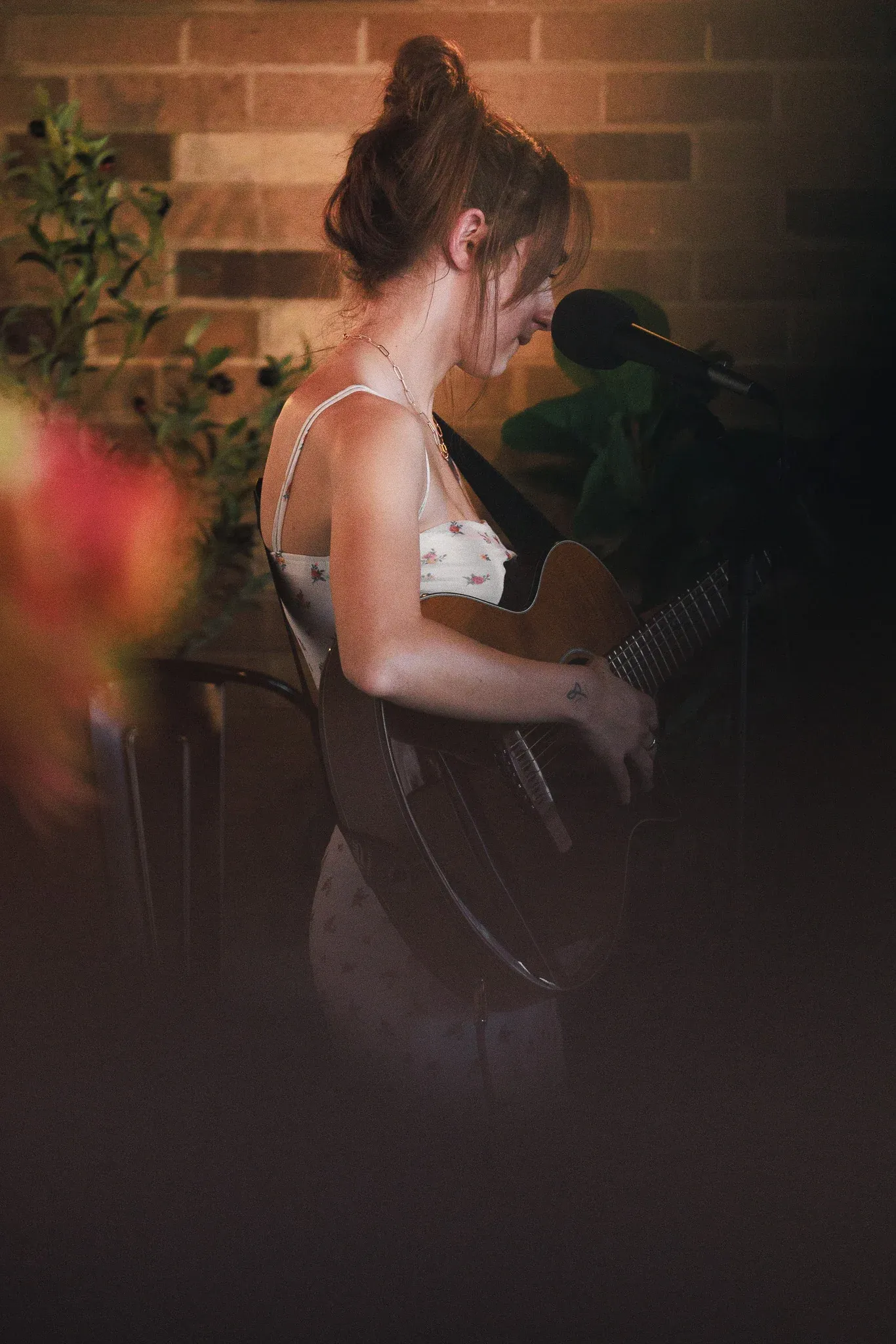 Singer performing beside a microphone